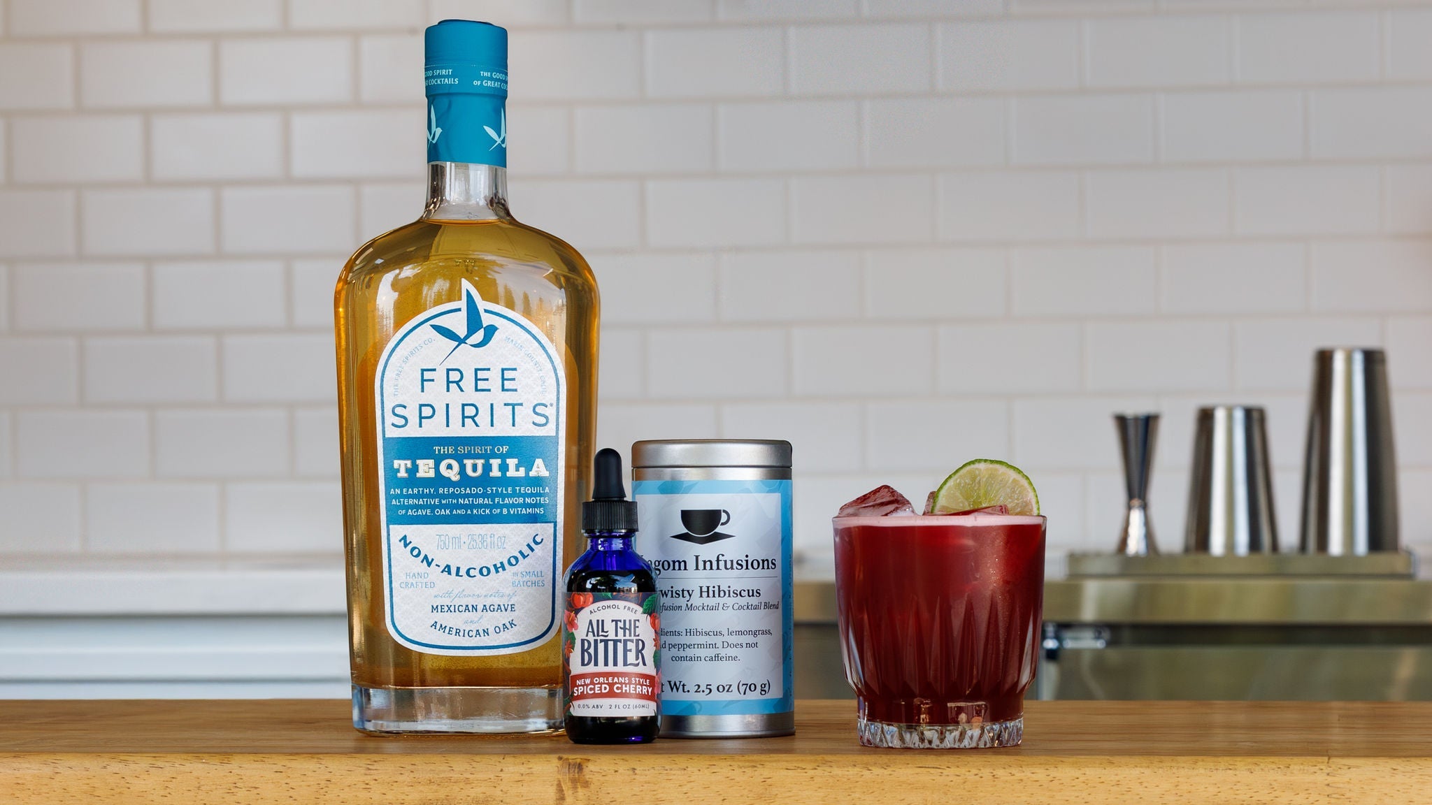 Image of a non-alcoholic mocktail made with Free Spirits Tequila alternative, hibiscus tea, and All The Bitter spiced cherry bitters.