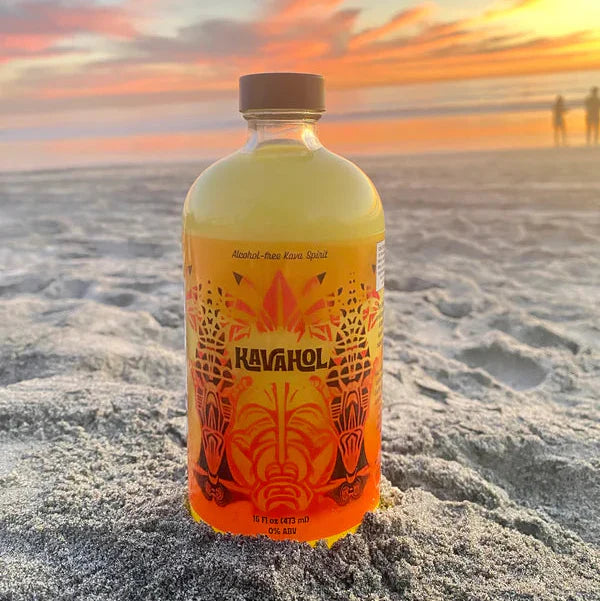 bottle of kavahol on the beach with the sunset in the background
