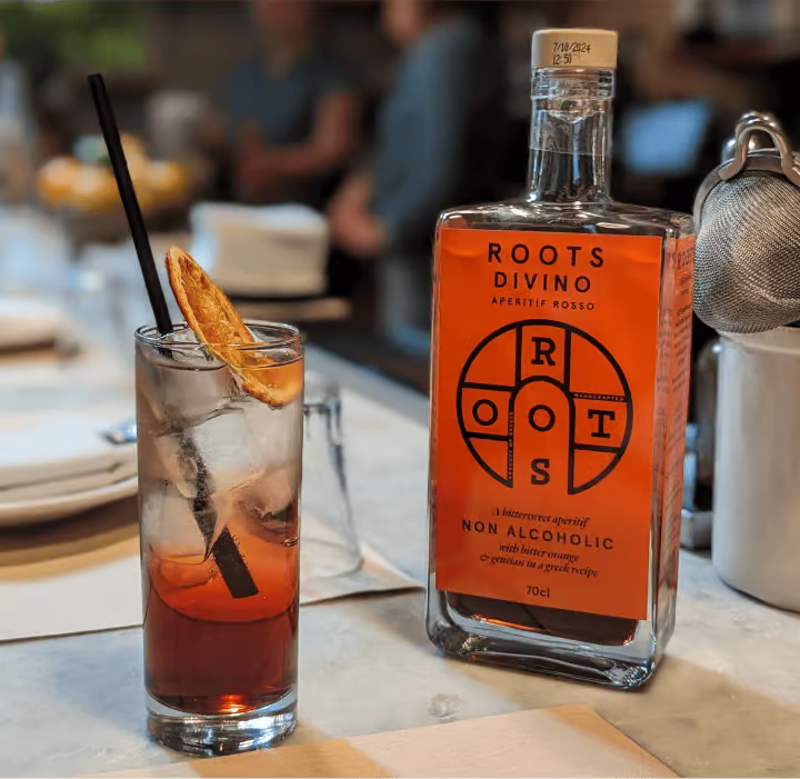 roots divino sweet vermouth non alcoholic with a cocktail glass